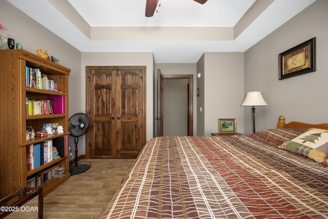 12244 County Rd 227, Oronogo, MO 64855 - bedroom featuring wood finished floors, a closet, ceiling fan, and a tray ceiling