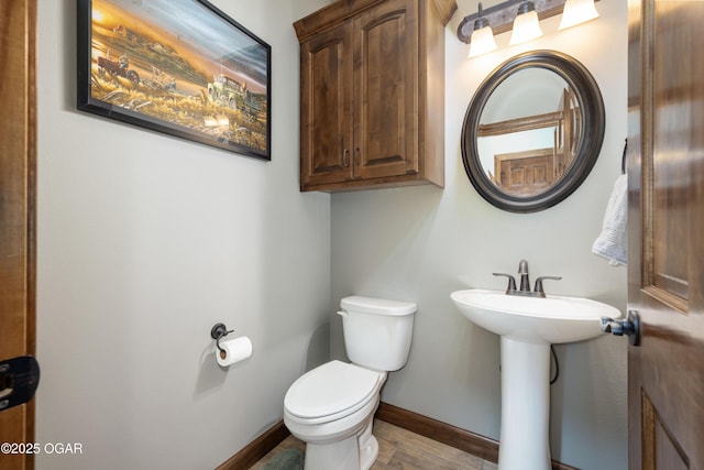 12244 County Rd 227, Oronogo, MO 64855 - bathroom with toilet, baseboards, wood finished floors, and a sink