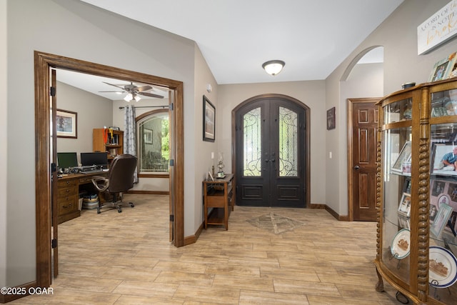 12244 County Rd 227, Oronogo, MO 64855 - foyer entrance featuring arched walkways, french doors, light wood-type flooring, and healthy amount of natural light