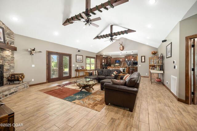 12244 County Rd 227, Oronogo, MO 64855 - living area featuring light wood-style flooring, a fireplace, ceiling fan, high vaulted ceiling, and baseboards