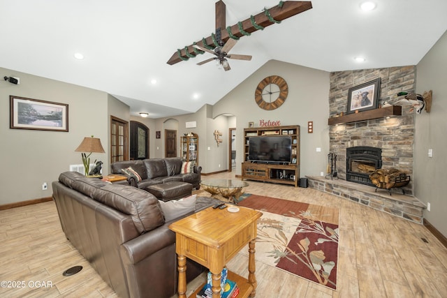 12244 County Rd 227, Oronogo, MO 64855 - living room featuring ceiling fan, light wood-type flooring, arched walkways, vaulted ceiling, and a fireplace