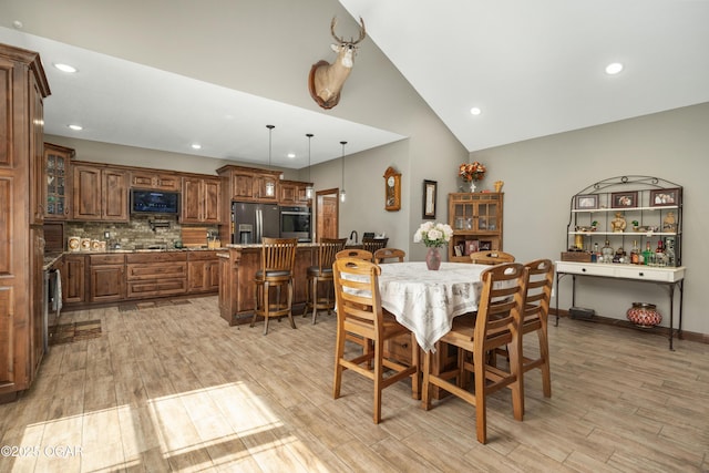 12244 County Rd 227, Oronogo, MO 64855 - dining area featuring light wood-style flooring, recessed lighting, and high vaulted ceiling