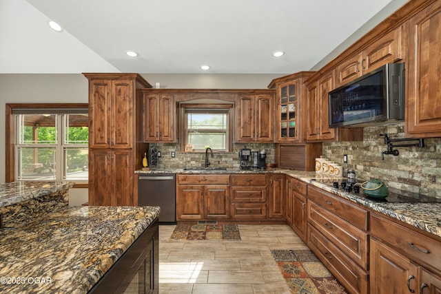 12244 County Rd 227, Oronogo, MO 64855 - kitchen with dishwasher, a sink, black electric cooktop, tasteful backsplash, and dark stone counters