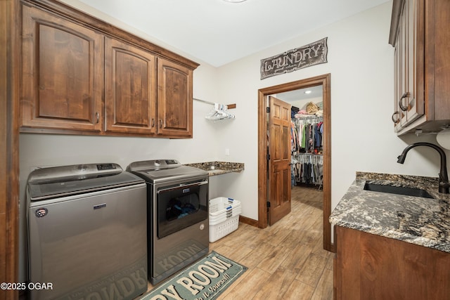12244 County Rd 227, Oronogo, MO 64855 - washroom featuring cabinet space, washing machine and dryer, light wood-style floors, and baseboards