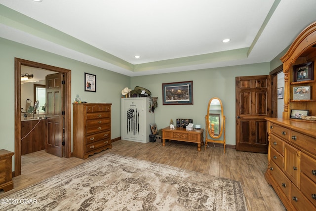 12244 County Rd 227, Oronogo, MO 64855 - bedroom featuring light wood-type flooring, a raised ceiling, recessed lighting, and baseboards