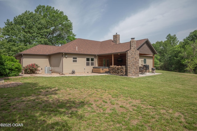 12244 County Rd 227, Oronogo, MO 64855 - back of property featuring a hot tub, a patio, a chimney, and a yard