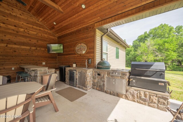 12244 County Rd 227, Oronogo, MO 64855 - view of patio with an outdoor kitchen, grilling area, wine cooler, and outdoor dining space