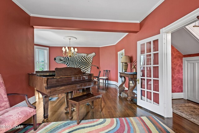 living area with wood finished floors, a chandelier, ornamental molding, and baseboards