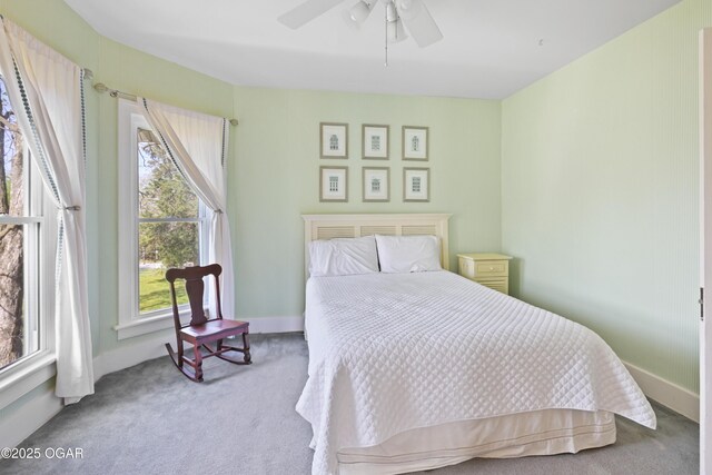 bedroom with carpet, baseboards, and a ceiling fan