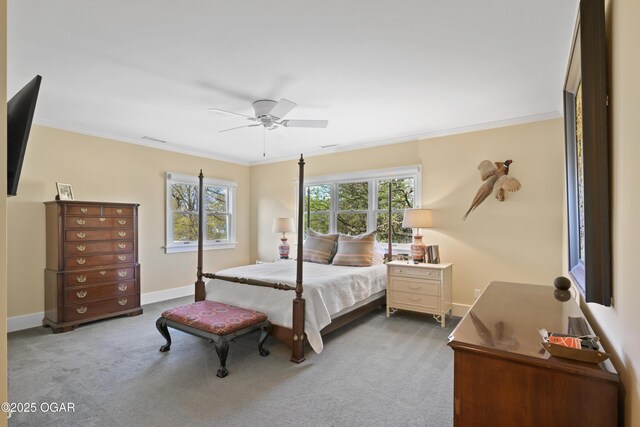 carpeted bedroom featuring crown molding, baseboards, and a ceiling fan