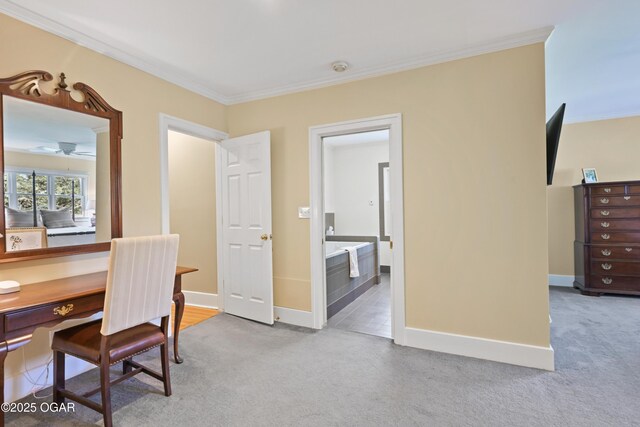 carpeted office with crown molding, baseboards, and ceiling fan