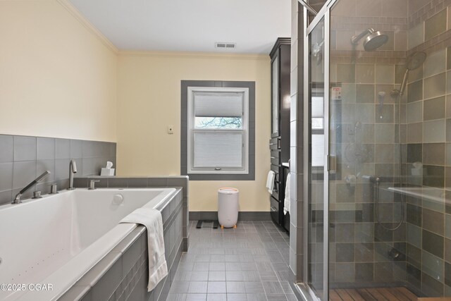 bathroom featuring a stall shower, ornamental molding, a bath, baseboards, and tile patterned flooring