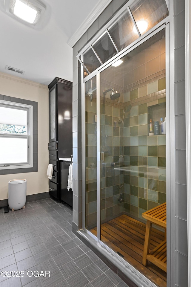 full bath with a stall shower, crown molding, and baseboards
