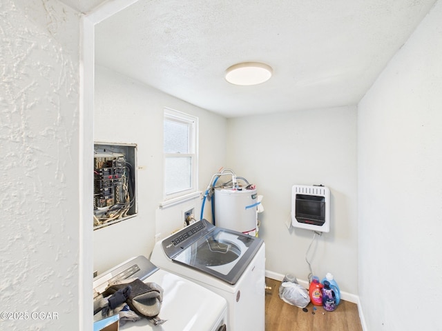720 Chestnut Ave, Joplin, MO 64801 - laundry area with heating unit, washing machine and dryer, water heater, wood finished floors, and baseboards