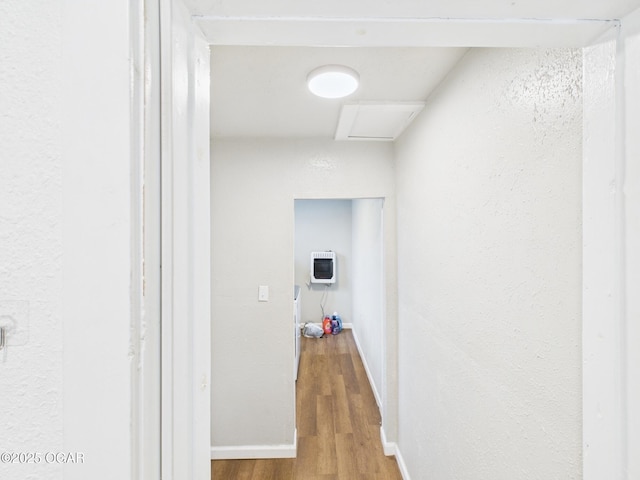 720 Chestnut Ave, Joplin, MO 64801 - corridor featuring heating unit, wood finished floors, baseboards, a textured wall, and attic access