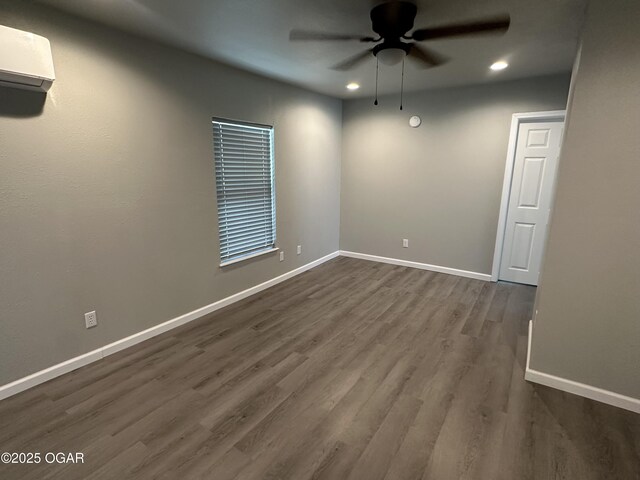720 Chestnut Ave, Joplin, MO 64801 - empty room with ceiling fan, recessed lighting, dark wood-style floors, baseboards, and a wall unit AC