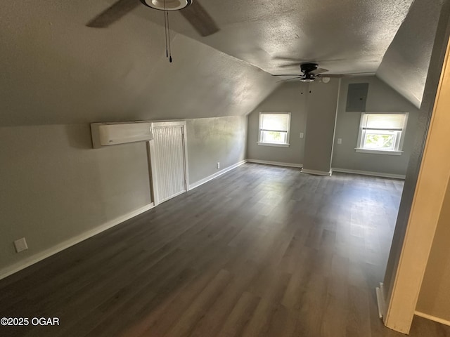 720 Chestnut Ave, Joplin, MO 64801 - additional living space featuring ceiling fan, a textured ceiling, dark wood-style floors, baseboards, and lofted ceiling