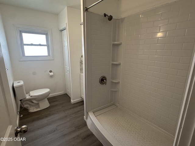 720 Chestnut Ave, Joplin, MO 64801 - bathroom featuring toilet, a shower, wood finished floors, and baseboards
