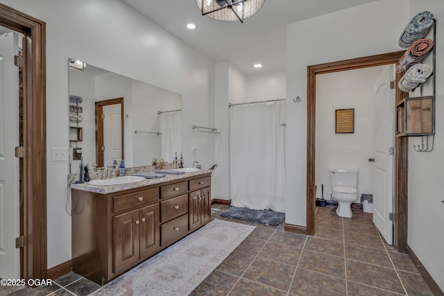 full bathroom with baseboards, toilet, double vanity, tile patterned flooring, and recessed lighting