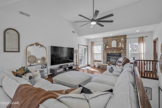 living room featuring high vaulted ceiling, a ceiling fan, wood finished floors, a fireplace, and recessed lighting