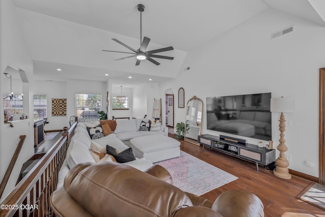 living area featuring a chandelier, high vaulted ceiling, a ceiling fan, wood finished floors, and recessed lighting