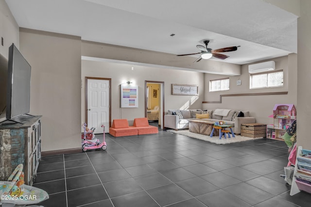 rec room featuring dark tile patterned floors, a wall mounted air conditioner, and ceiling fan