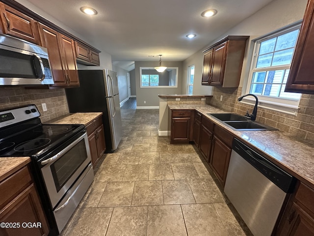 216 N Connor Ave, Joplin, MO 64801 - kitchen with appliances with stainless steel finishes, a sink, baseboards, decorative backsplash, and recessed lighting