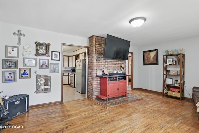 living area with light wood-style floors and baseboards