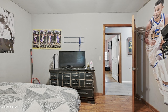 bedroom with wood finished floors and baseboards