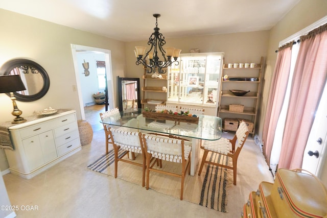 608 Sycamore Ln, Pittsburg, KS 66762 - dining space featuring a chandelier and light carpet