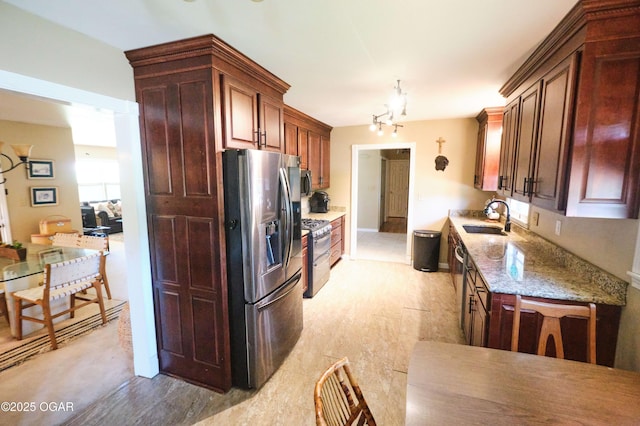 608 Sycamore Ln, Pittsburg, KS 66762 - kitchen featuring stainless steel appliances, a sink, light stone counters, and a chandelier