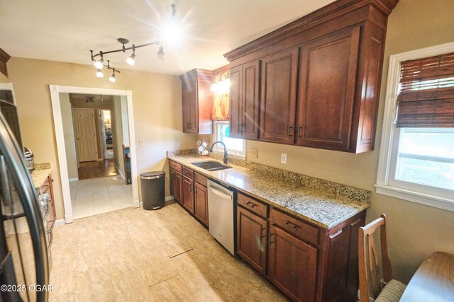 608 Sycamore Ln, Pittsburg, KS 66762 - kitchen with stainless steel dishwasher, a sink, healthy amount of natural light, and light stone counters