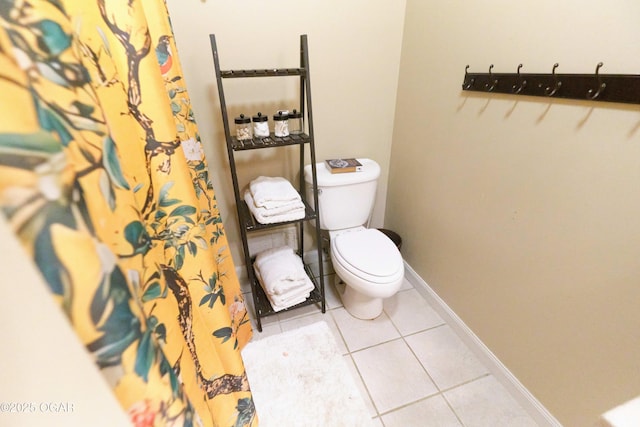 608 Sycamore Ln, Pittsburg, KS 66762 - bathroom with tile patterned floors, toilet, and baseboards