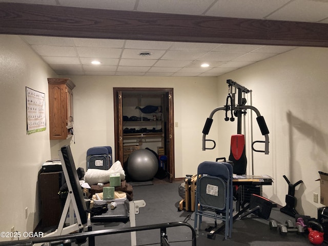 exercise area featuring a paneled ceiling and recessed lighting