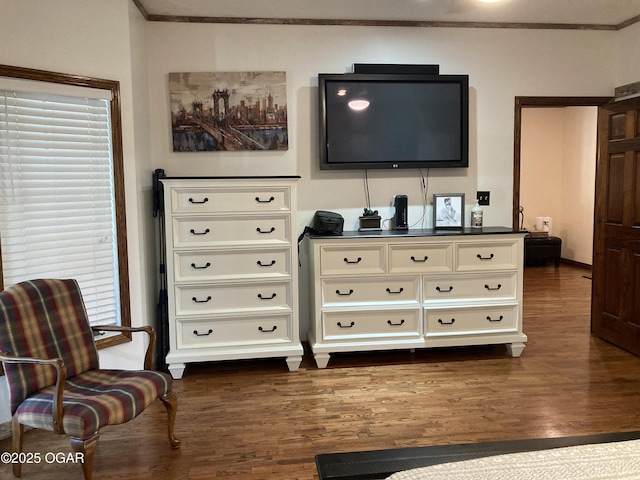 living area with crown molding, dark wood-style floors, and healthy amount of natural light