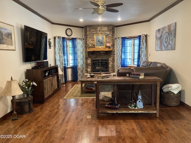 living room featuring ornamental molding, healthy amount of natural light, ceiling fan, and wood finished floors