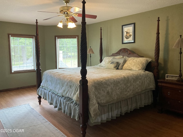 bedroom with wood finished floors, ceiling fan, and baseboards