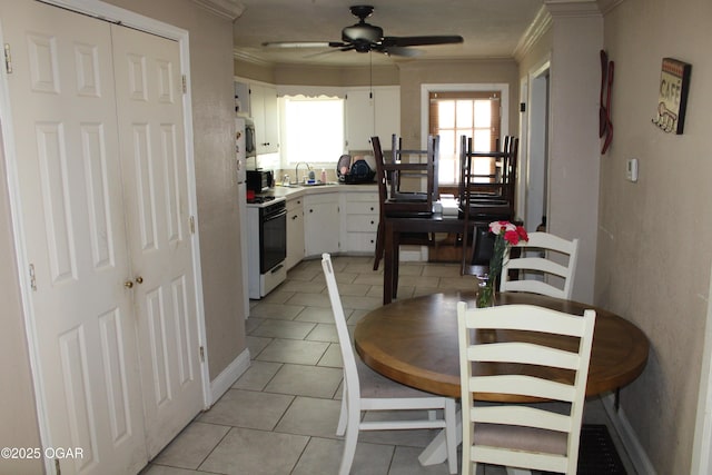 504 E Jackson St, Pittsburg, KS 66762 - dining room featuring ornamental molding, light tile patterned floors, and a ceiling fan