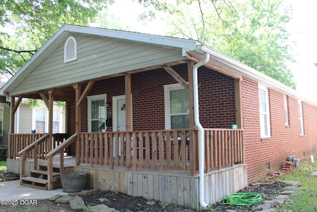 504 E Jackson St, Pittsburg, KS 66762 - view of front of house with brick siding, crawl space, and a wooden deck