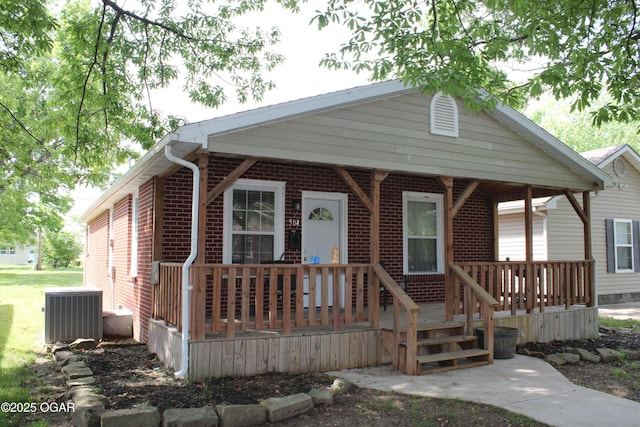 504 E Jackson St, Pittsburg, KS 66762 - view of front of property featuring central air condition unit, covered porch, and brick siding