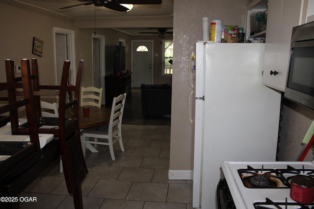 504 E Jackson St, Pittsburg, KS 66762 - dining area with ceiling fan, crown molding, and tile patterned flooring