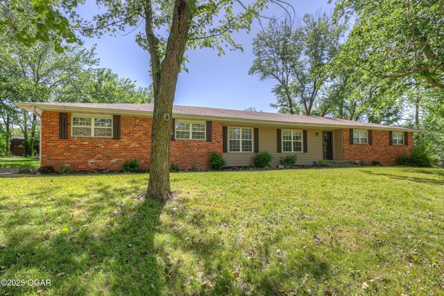 1912 N Duquesne Rd, Joplin, MO 64801 - ranch-style home with a front yard and brick siding