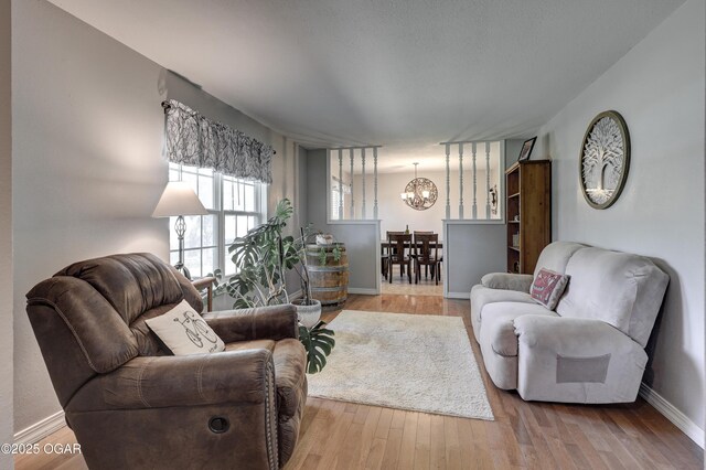 1912 N Duquesne Rd, Joplin, MO 64801 - living area with a chandelier, wood finished floors, and baseboards