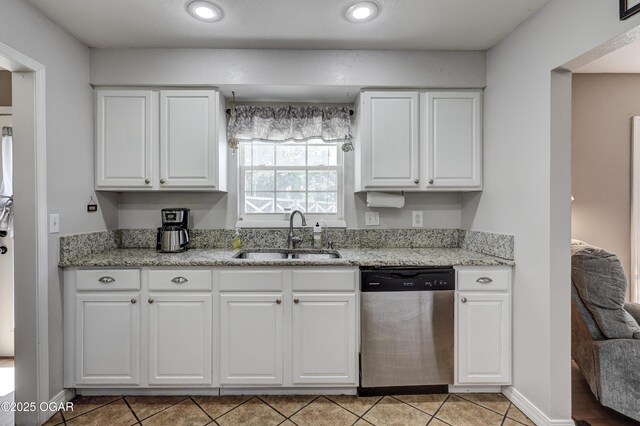 1912 N Duquesne Rd, Joplin, MO 64801 - kitchen featuring stainless steel dishwasher, a sink, white cabinets, light tile patterned floors, and recessed lighting
