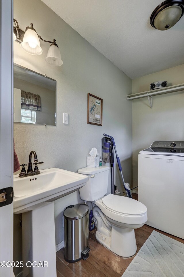 1912 N Duquesne Rd, Joplin, MO 64801 - half bathroom with washer / dryer, wood finished floors, and toilet