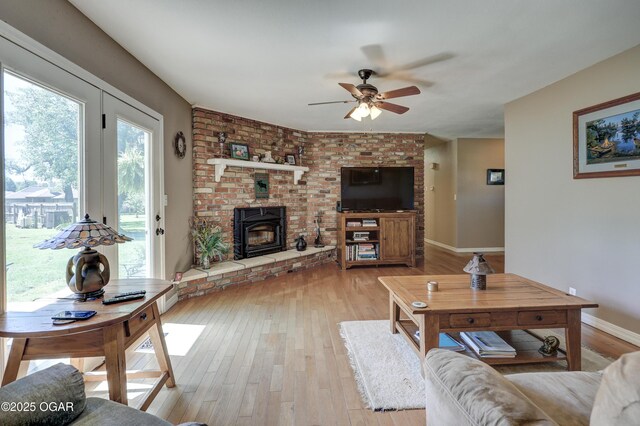 1912 N Duquesne Rd, Joplin, MO 64801 - living area with a ceiling fan, light wood-style flooring, baseboards, and a brick fireplace