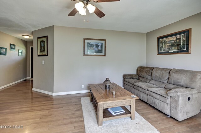 1912 N Duquesne Rd, Joplin, MO 64801 - living room featuring light wood-type flooring, ceiling fan, and baseboards