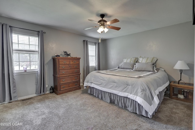 1912 N Duquesne Rd, Joplin, MO 64801 - carpeted bedroom with multiple windows and ceiling fan