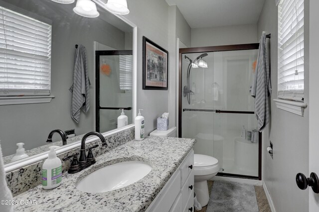 1912 N Duquesne Rd, Joplin, MO 64801 - bathroom featuring vanity, a stall shower, and toilet