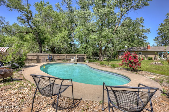 1912 N Duquesne Rd, Joplin, MO 64801 - view of swimming pool featuring a fenced backyard, a patio area, and view of wooded area